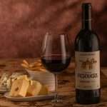 Gourmet wine and cheese setup featuring Tinto Pesquera bottle, ideal for culinary enthusiasts.