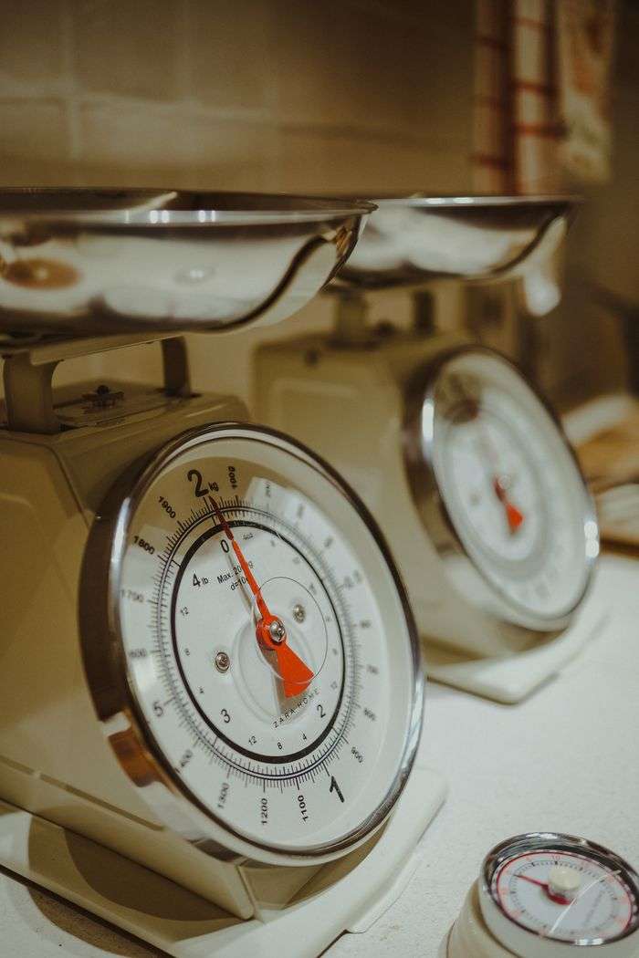 Close-up of classic metal analog kitchen scales with precise measurement.